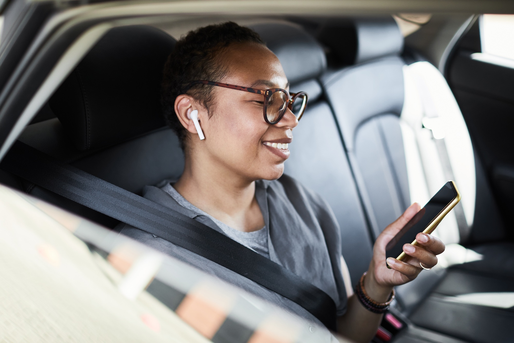 Businesswoman using phone in car